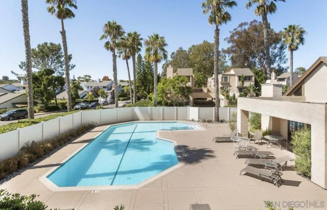 a view of a yard with yellow walls