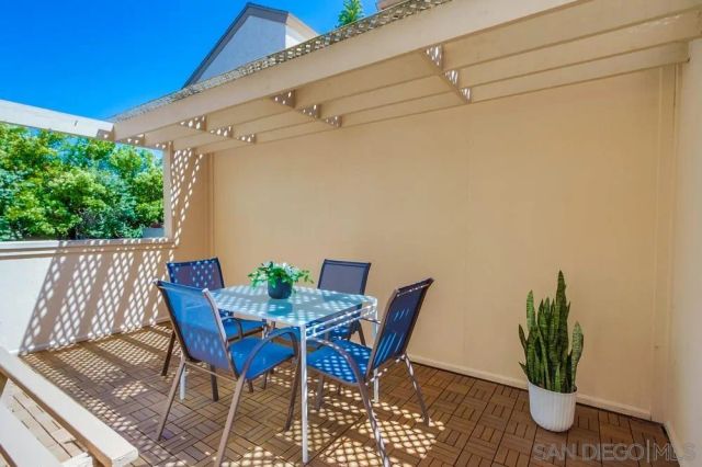 a view of patio with table and chairs and potted plants
