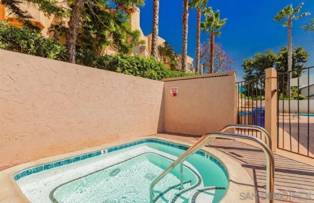 a view of a garden with a slide and a tree