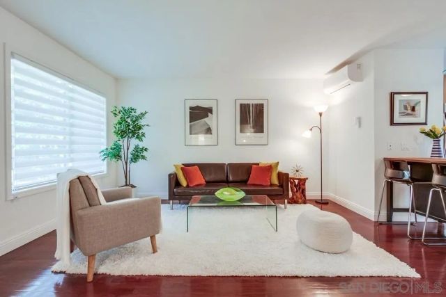 a living room with furniture and a potted plant