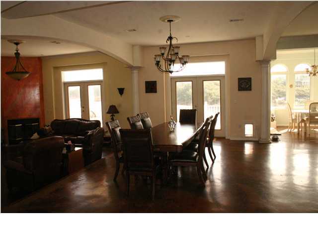 249 Old Beach Road Santa Rosa Beach, FL 32459 - Photo 8 of 16 a living room with dining room furniture and a chandelier