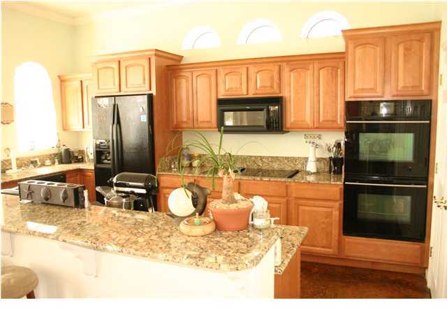 249 Old Beach Road Santa Rosa Beach, FL 32459 - Photo 9 of 16 a kitchen with a refrigerator sink and stove