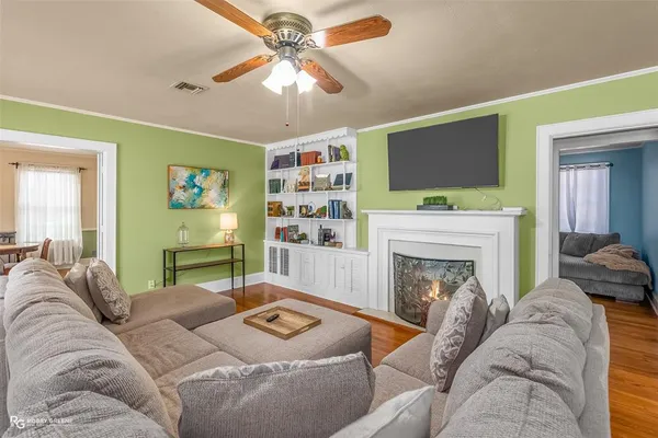 a living room with furniture a flat screen tv and a fireplace