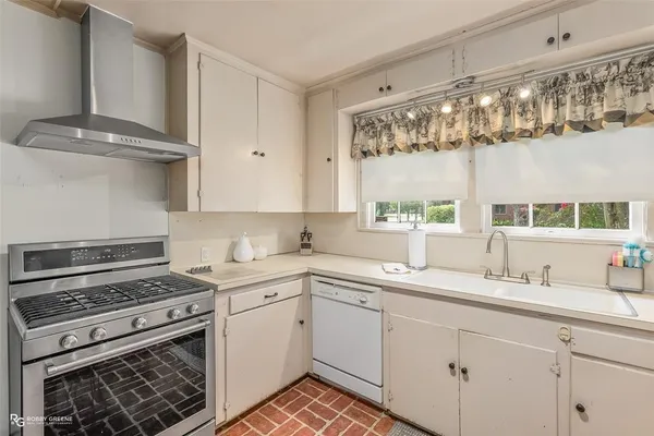 a kitchen with a sink stove and cabinets