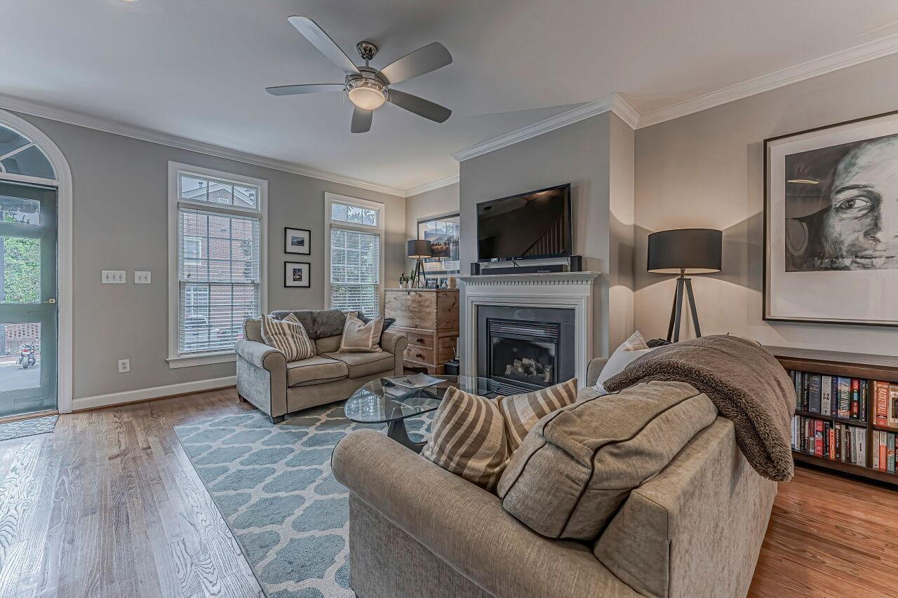 106 Hatfield Lane Raleigh, NC 27603 - Photo 4 of 29 a living room with furniture a flat screen tv and a fireplace