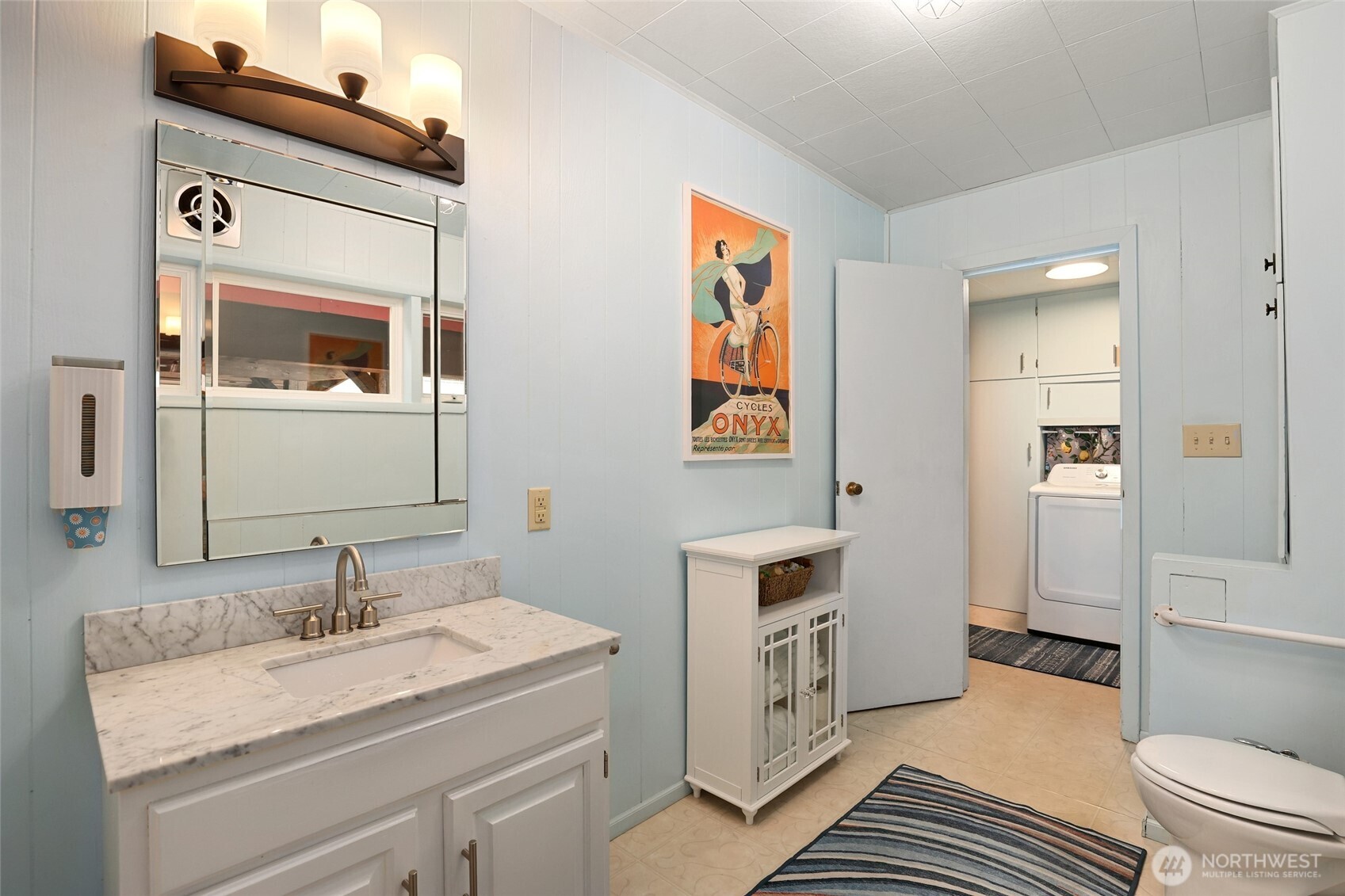 215 H Street Cosmopolis, WA 98537 - Photo 22 of 40 a en suite bathroom with a granite countertop sink and a mirror