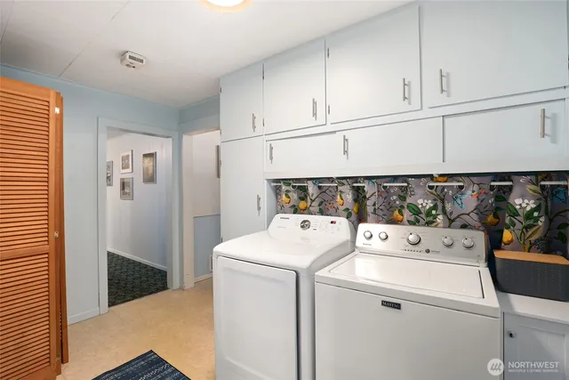 a view of an empty room with furniture and a window