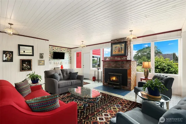 a living room with furniture flat screen tv and a fireplace