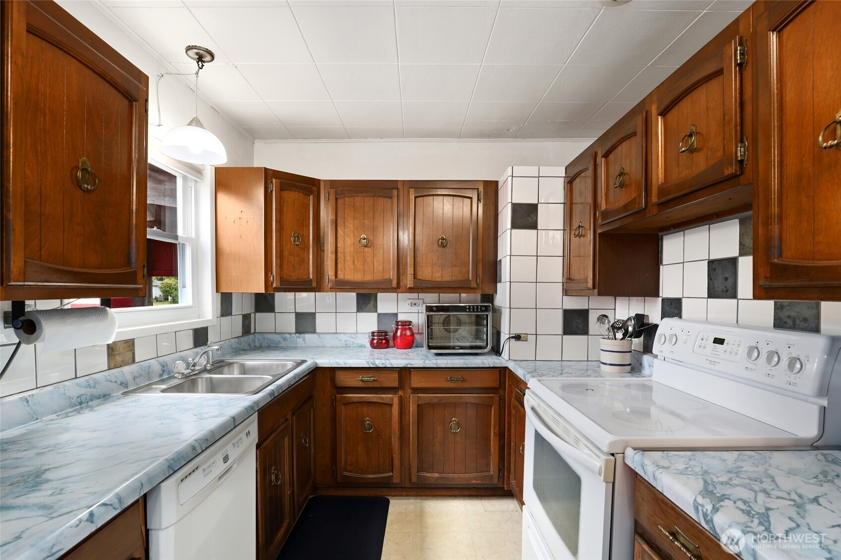 215 H Street Cosmopolis, WA 98537 - Photo 8 of 40 a kitchen with stainless steel appliances granite countertop a sink stove and cabinets