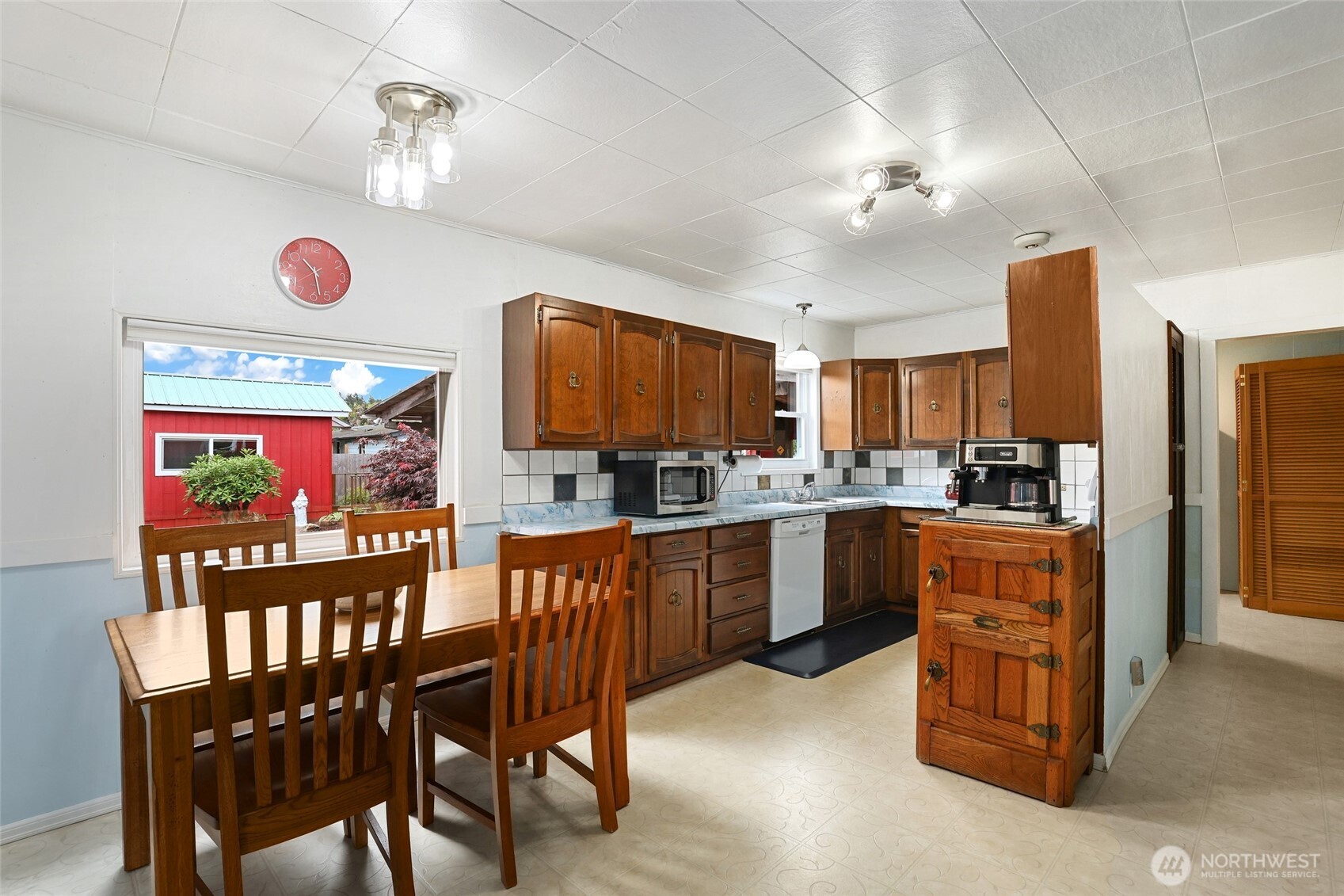215 H Street Cosmopolis, WA 98537 - Photo 10 of 40 a kitchen with stainless steel appliances granite countertop a stove top oven a sink dishwasher and white cabinets