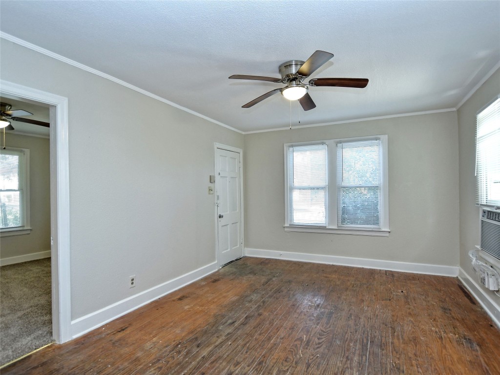 4305 Red River Street Austin, TX 78751 - Photo 3 of 9 Empty room with a ceiling fan, baseboards, ornamental molding, and plenty of natural light