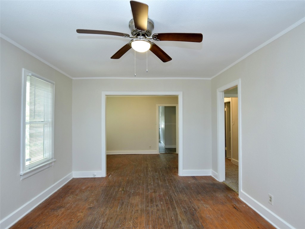 4305 Red River Street Austin, TX 78751 - Photo 4 of 9 Unfurnished room featuring wood-type flooring, ornamental molding, baseboards, and ceiling fan