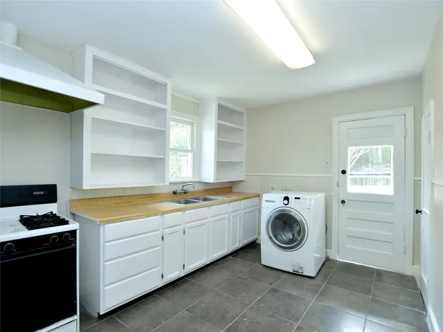a utility room with sink dryer and washer