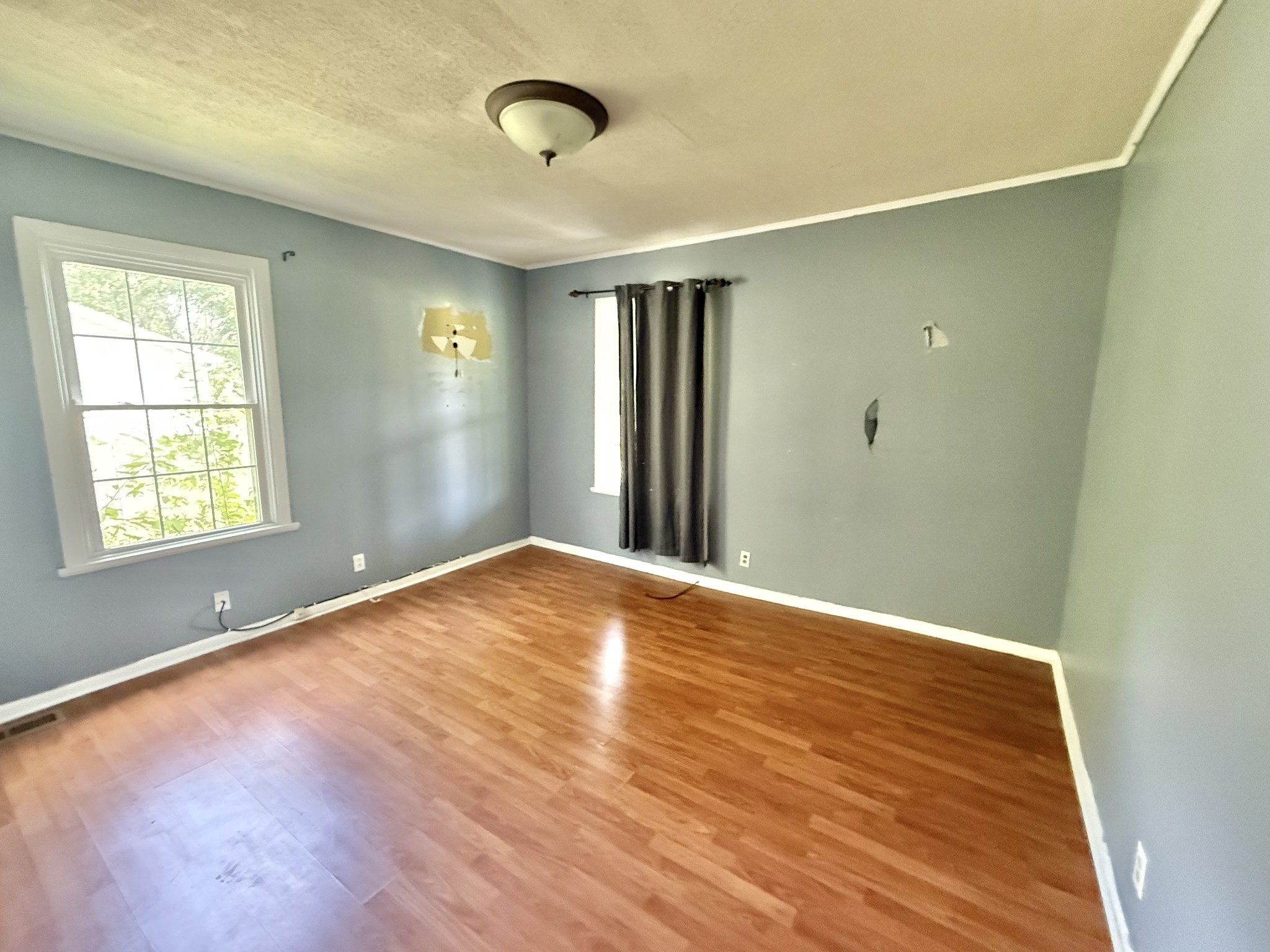 604 South Main Street St. Joseph, TN 38481 - Photo 9 of 10 an empty room with wooden floor and windows