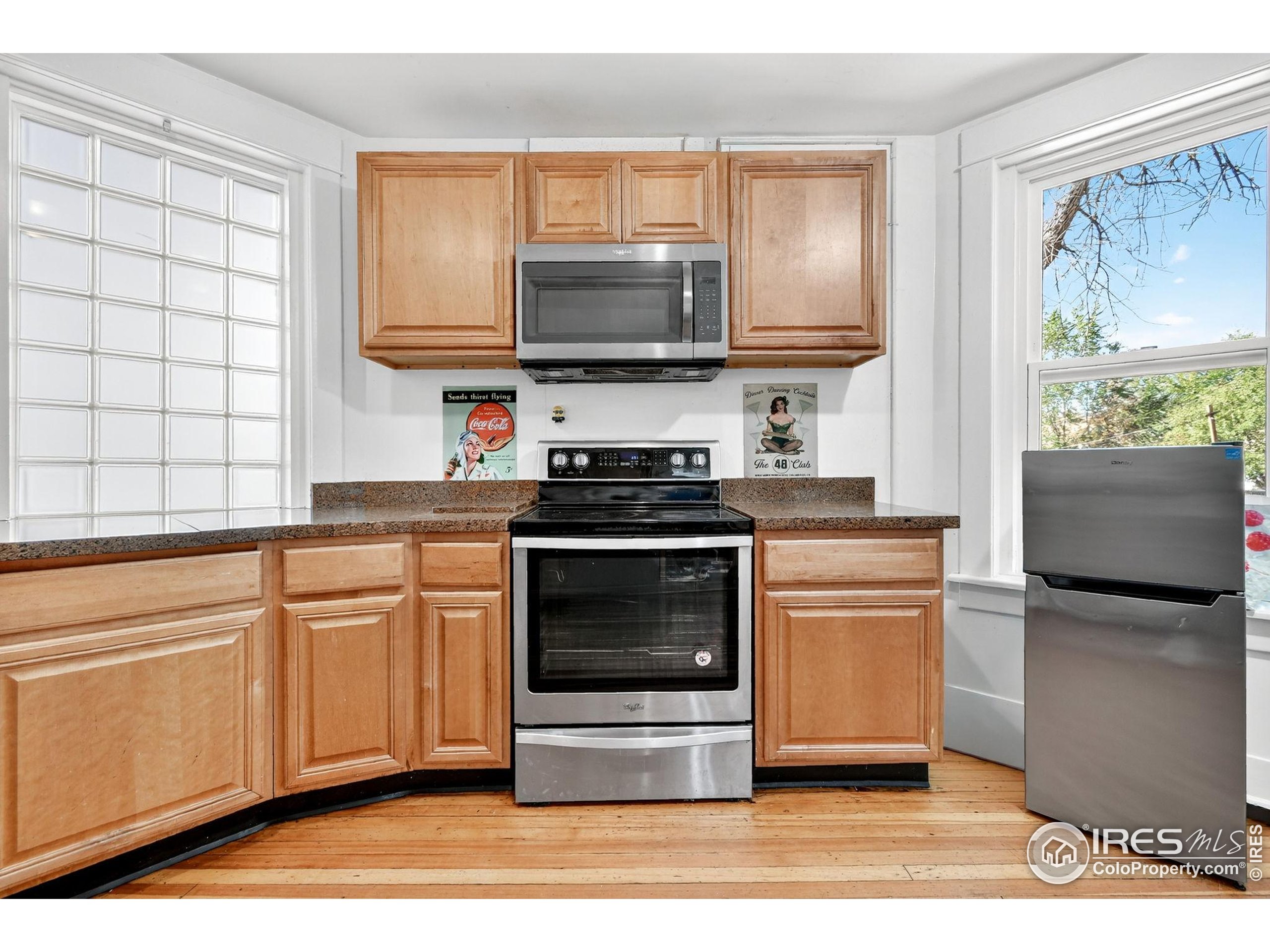972 Pleasant Street Boulder, CO 80302 - Photo 11 of 36 a kitchen with stainless steel appliances a stove microwave and sink