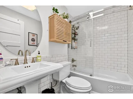a bathroom with a sink toilet a mirror and shower