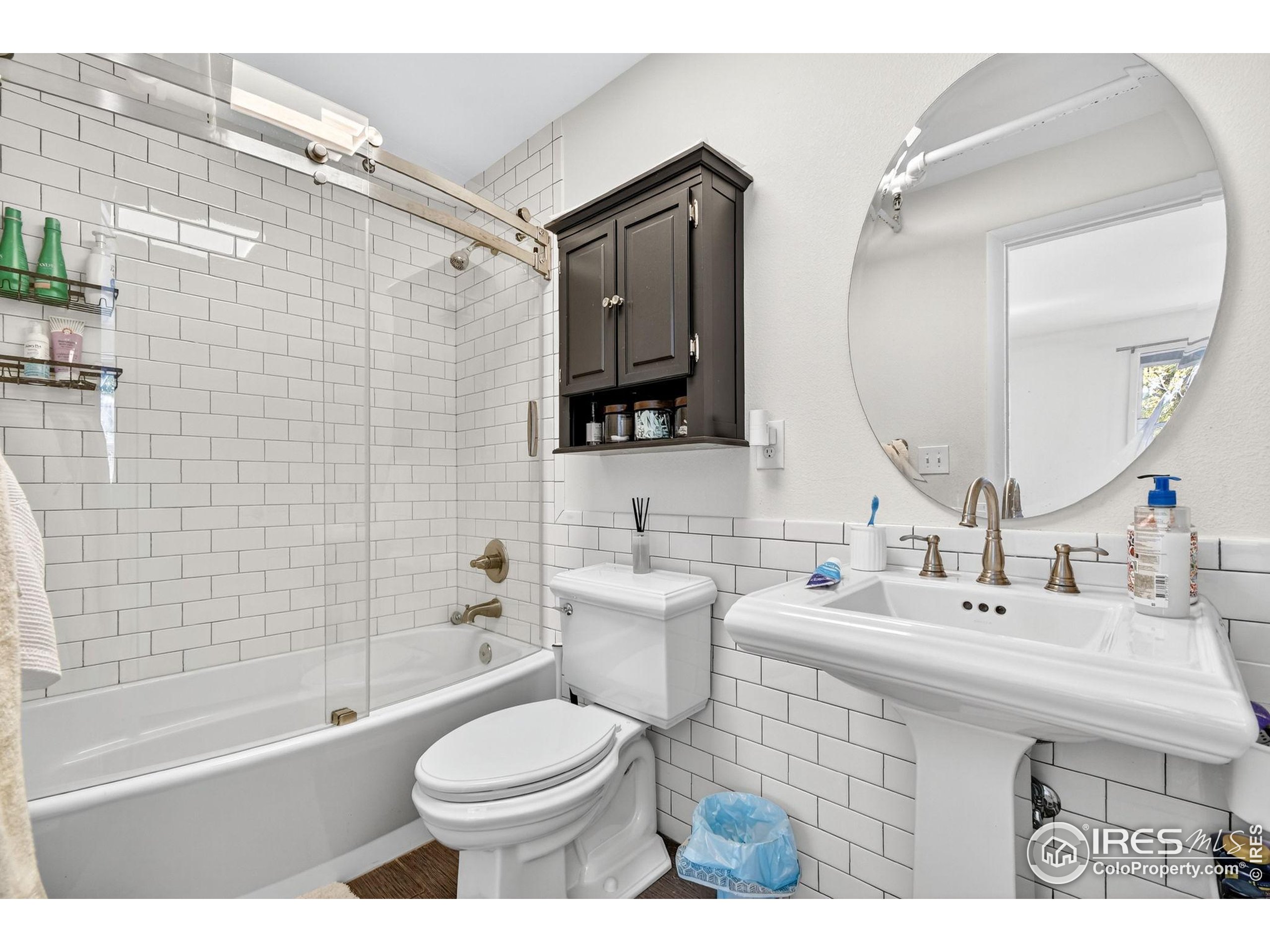 972 Pleasant Street Boulder, CO 80302 - Photo 21 of 36 a bathroom with a sink toilet mirror and shower