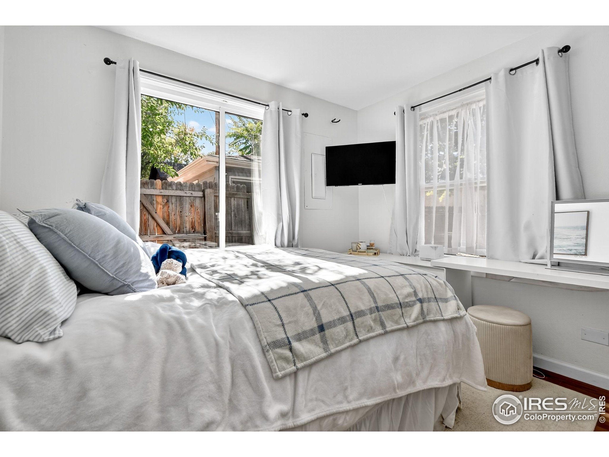 972 Pleasant Street Boulder, CO 80302 - Photo 23 of 36 a bedroom with a large bed and a window