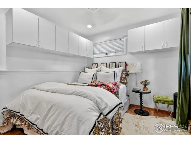 a bedroom with a bed and cabinets