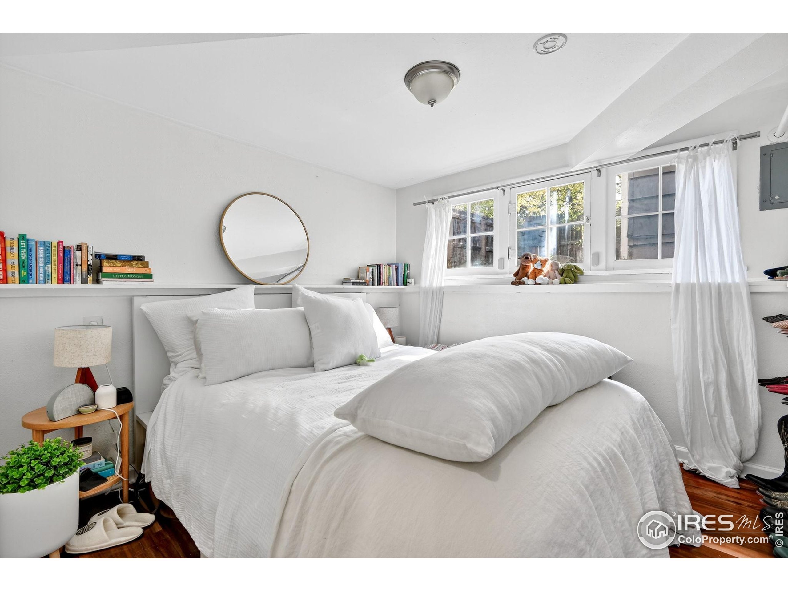 972 Pleasant Street Boulder, CO 80302 - Photo 25 of 36 a bedroom with a bed and a large window