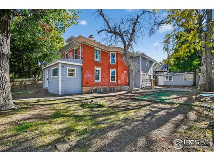 a view of a house with a backyard