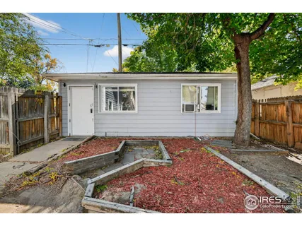 a backyard of a house with yard and outdoor seating