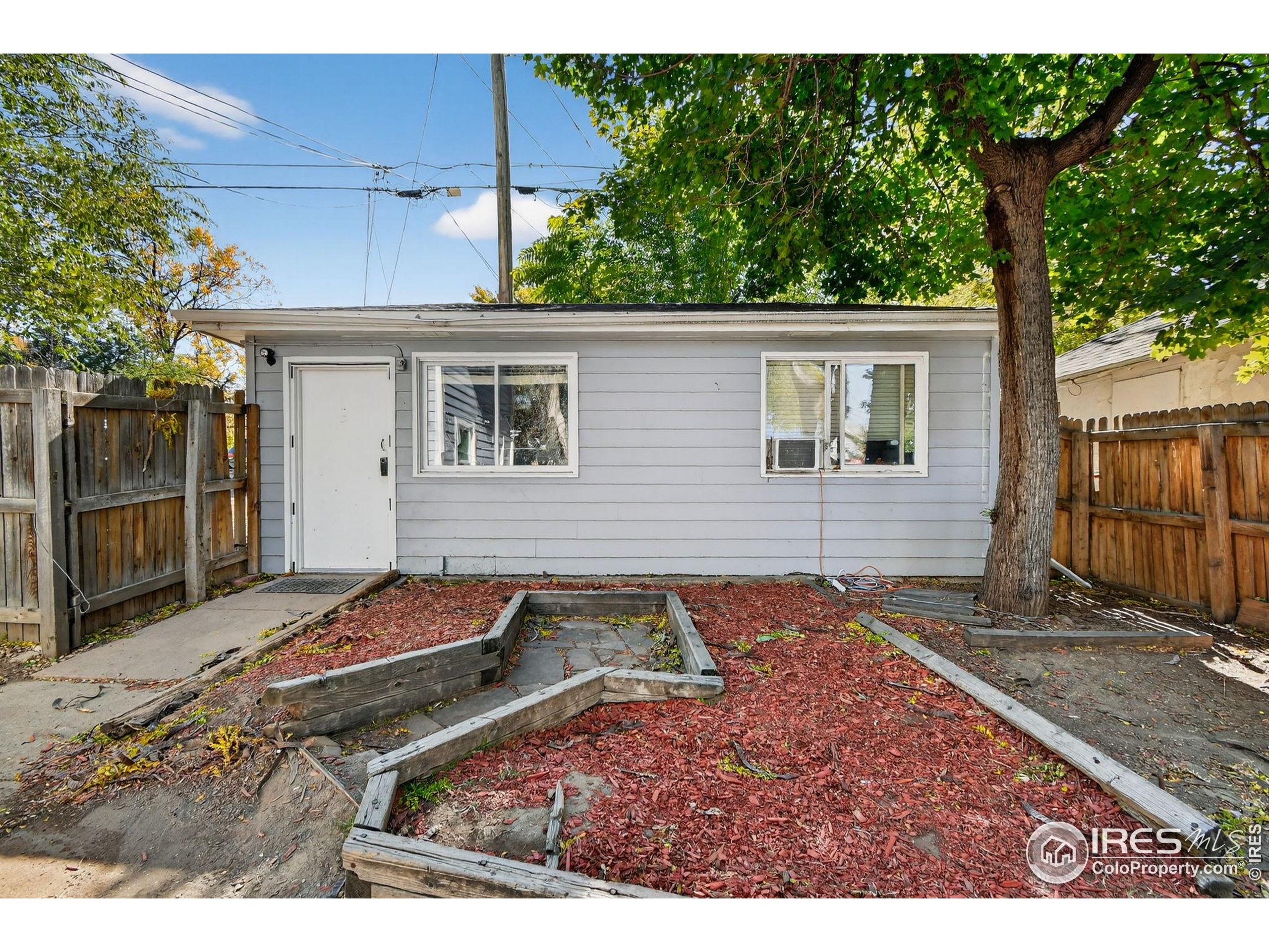 972 Pleasant Street Boulder, CO 80302 - Photo 34 of 36 a backyard of a house with yard and outdoor seating