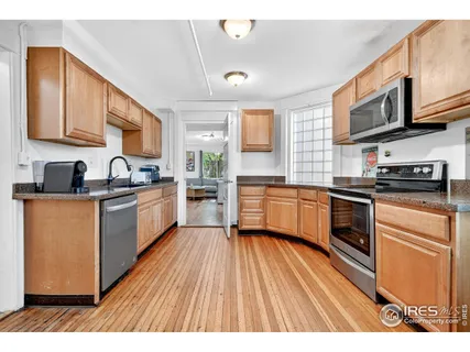 a kitchen with stainless steel appliances a refrigerator sink and cabinets