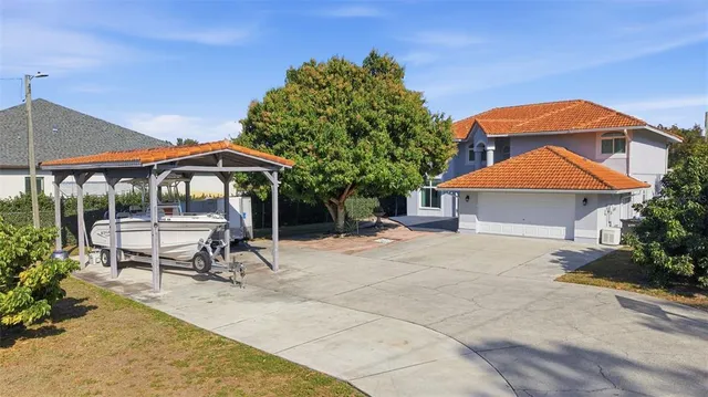 a view of a patio with a table and chairs under an umbrella