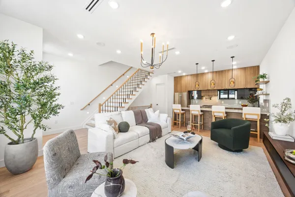 a living room with furniture and a chandelier