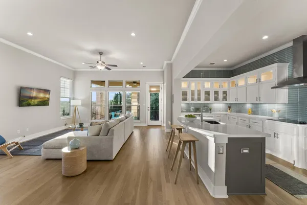 a kitchen with a sink appliances and a large window