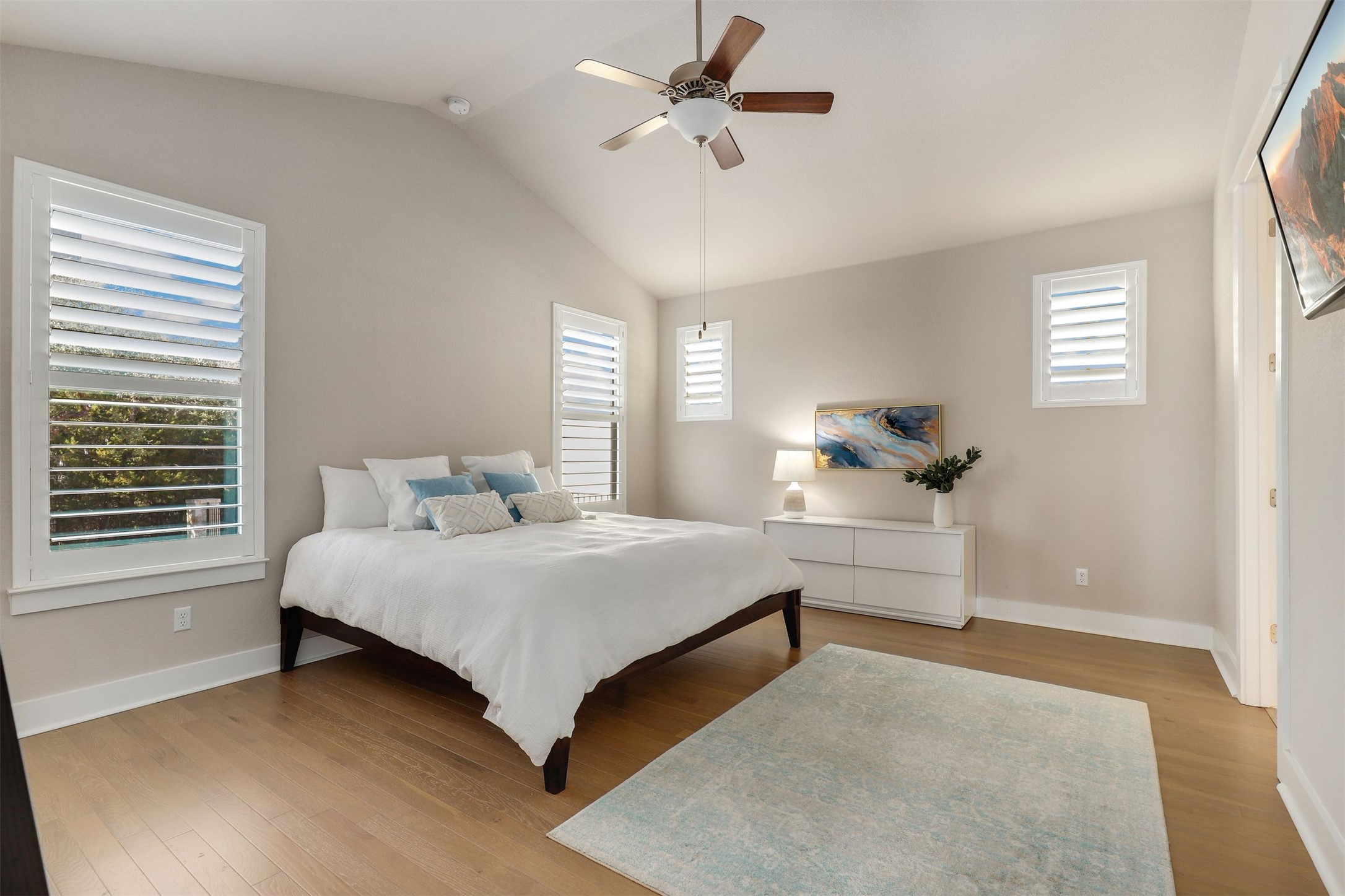 5502 Patagonia Pass Austin, TX 78738 - Photo 13 of 34 Bedroom with light wood-type flooring, a ceiling fan, and vaulted ceiling
