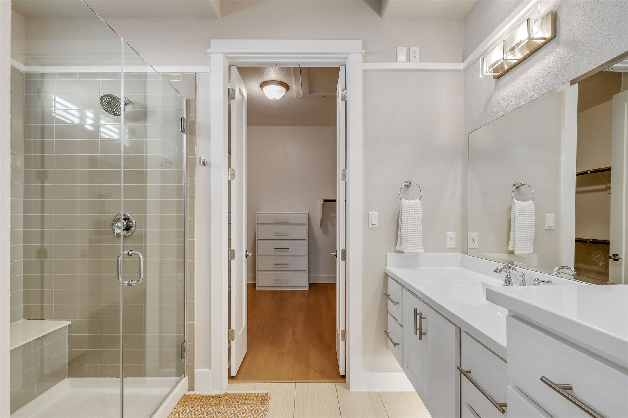5502 Patagonia Pass Austin, TX 78738 - Photo 15 of 34 Bathroom with a spacious closet, a stall shower, and vanity