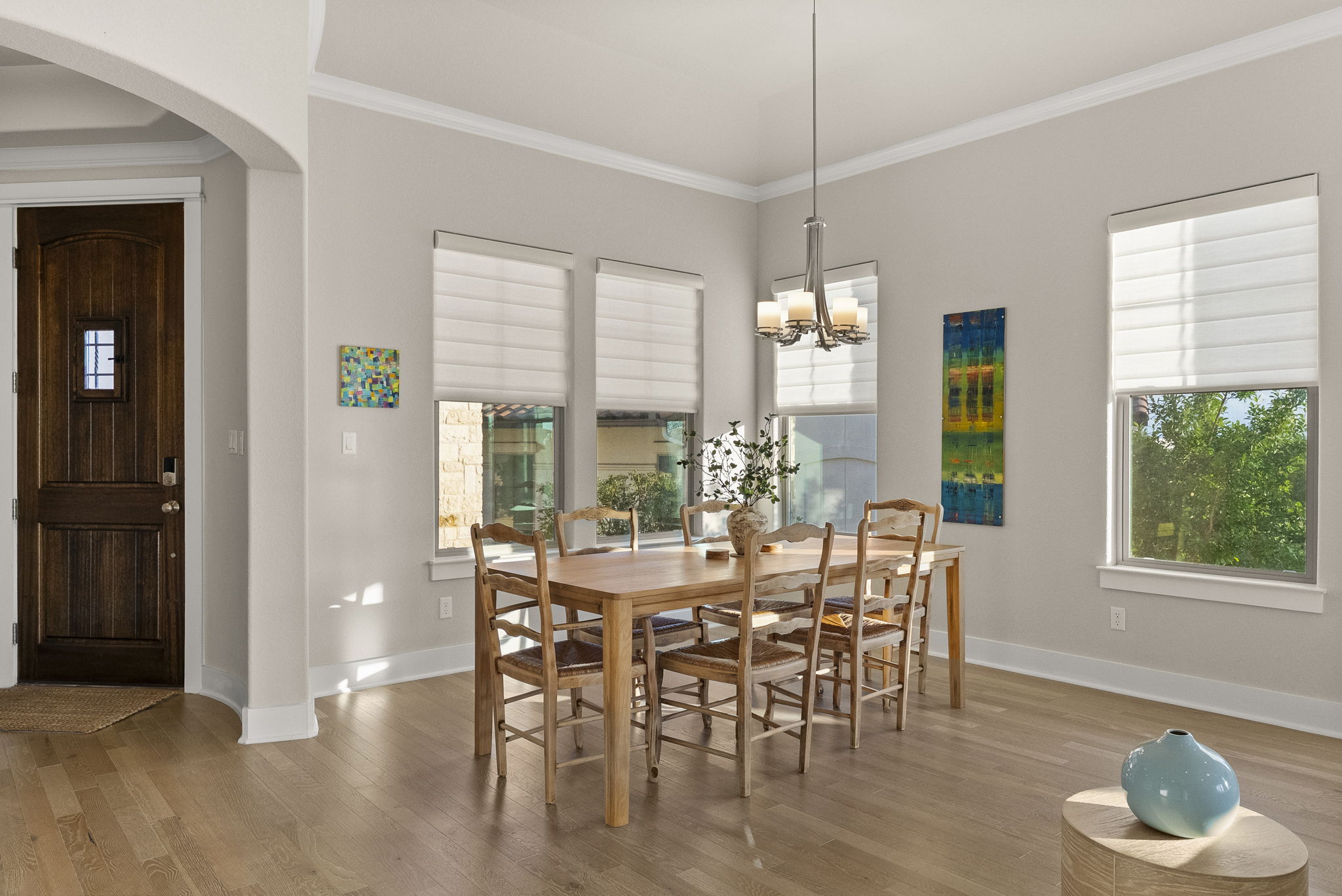 5502 Patagonia Pass Austin, TX 78738 - Photo 5 of 34 Dining room with arched walkways, ornamental molding, light wood-style floors, and healthy amount of natural light