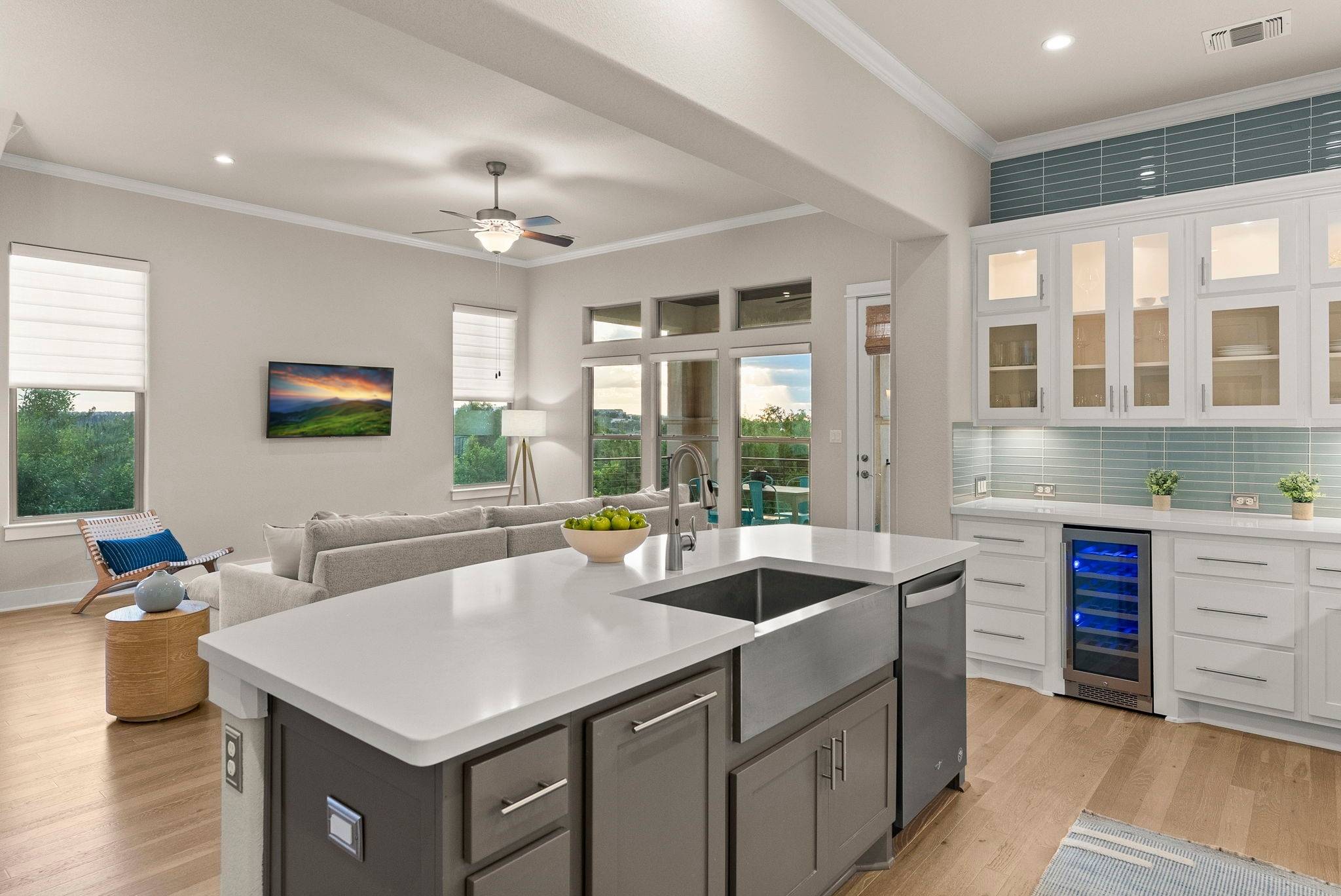 5502 Patagonia Pass Austin, TX 78738 - Photo 34 of 34 Kitchen with white cabinets, open floor plan, glass insert cabinets, ornamental molding, and gray cabinets