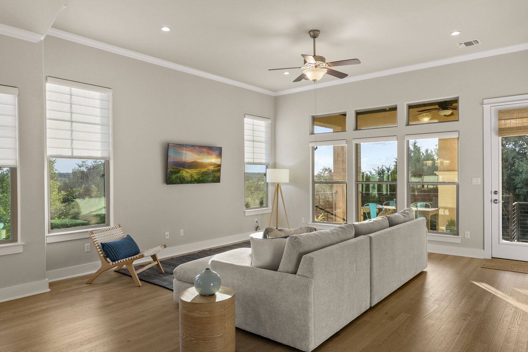5502 Patagonia Pass Austin, TX 78738 - Photo 7 of 34 Living room with hardwood / wood-style floors, crown molding, ceiling fan, healthy amount of natural light, and recessed lighting