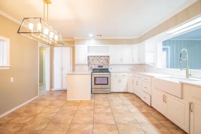 a kitchen with a stove a sink and a refrigerator