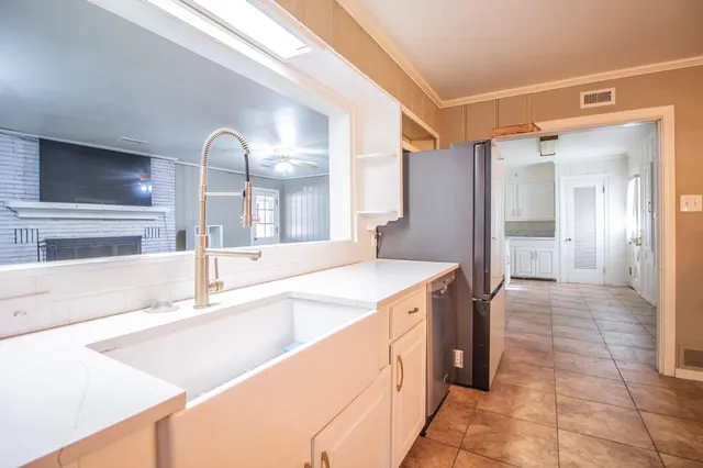 a kitchen with a sink and refrigerator