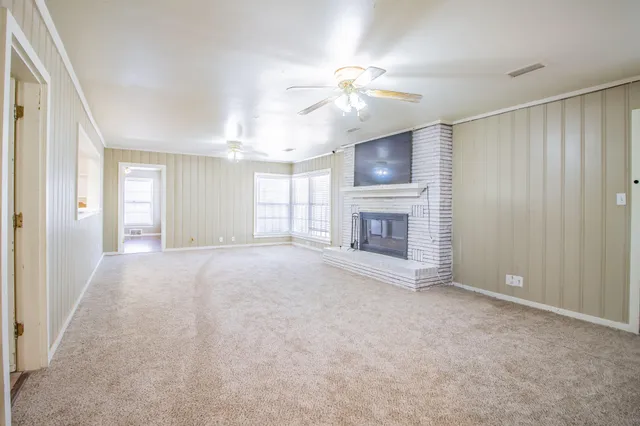 a view of empty room with a fireplace