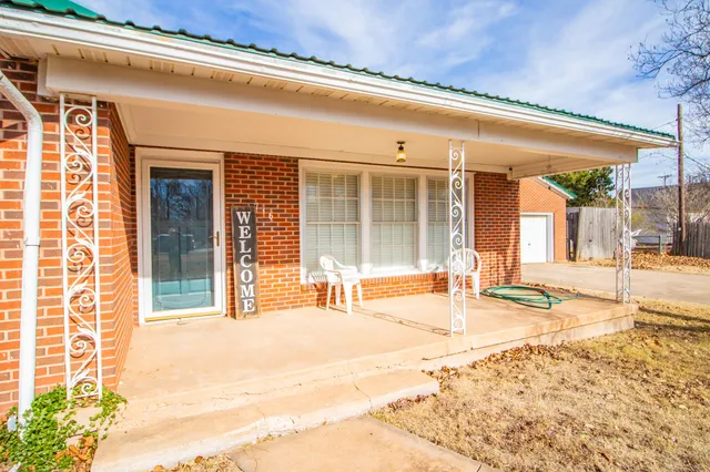 a swimming pool with table and chairs