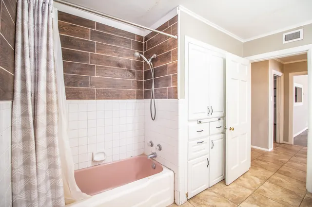 a bathroom with a bathtub and a shower