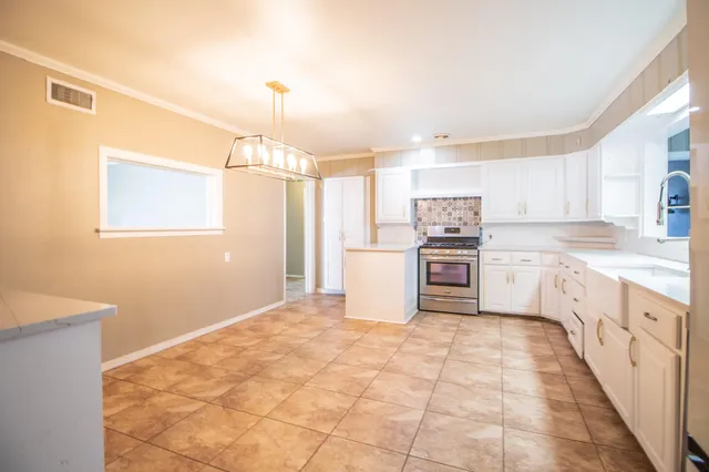 a kitchen with a stove a sink and a refrigerator