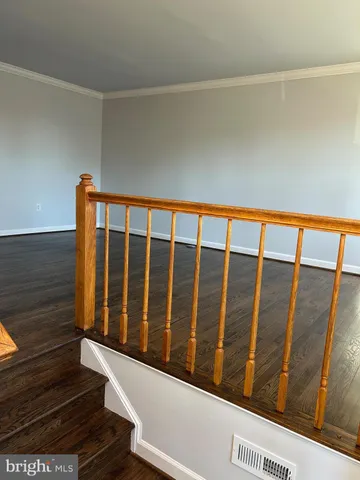 a kitchen with stainless steel appliances granite countertop a refrigerator a stove top oven a sink dishwasher and wooden floor