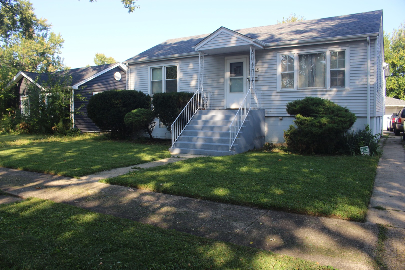a front view of a house with a garden and yard