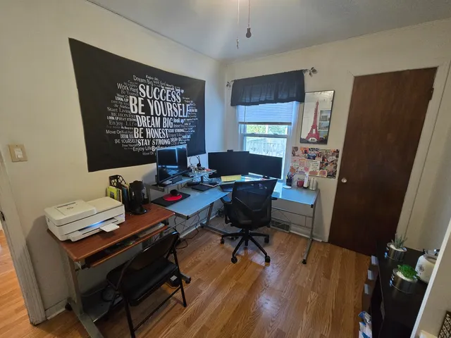 a workspace with furniture and wooden floor