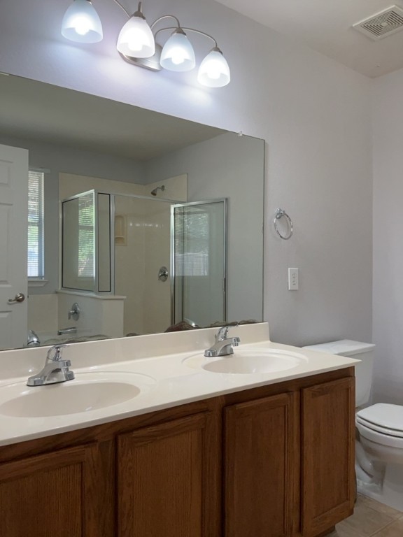 9005 Sun Shower Bend Austin, TX 78724 - Photo 12 of 20 a bathroom with a double vanity sink and a mirror