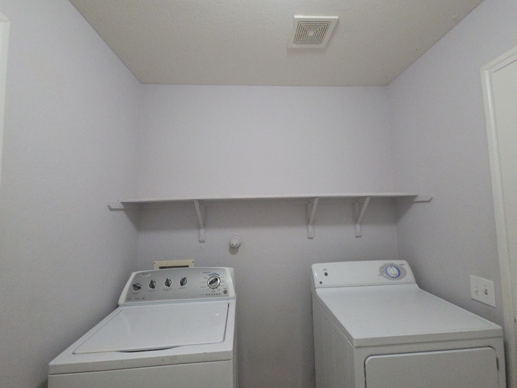 9005 Sun Shower Bend Austin, TX 78724 - Photo 19 of 20 a utility room with dryer and washer
