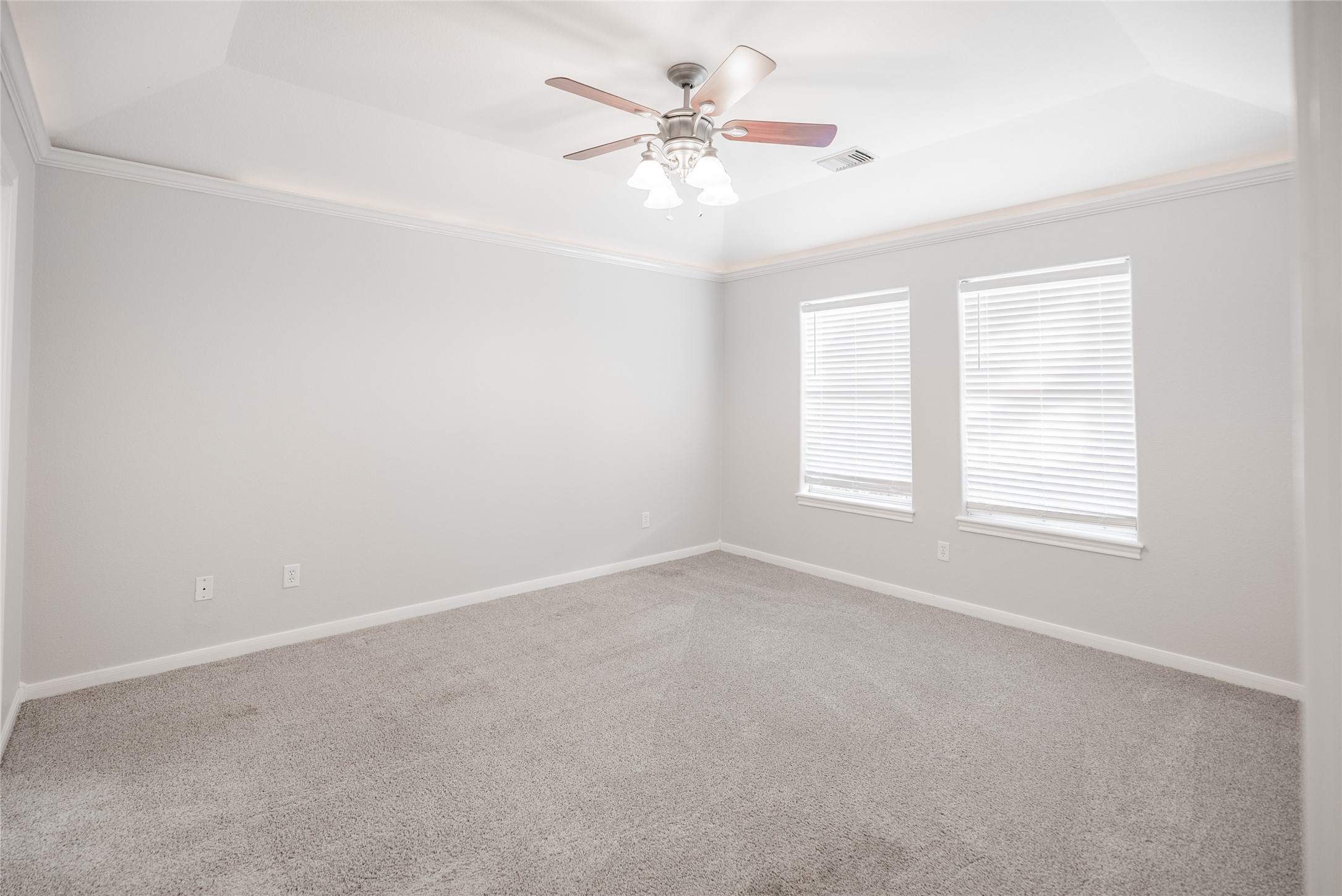 13165 Snow Lane, Unit 1 Willis, TX 77318 - Photo 12 of 34 an empty room with windows and chandelier fan