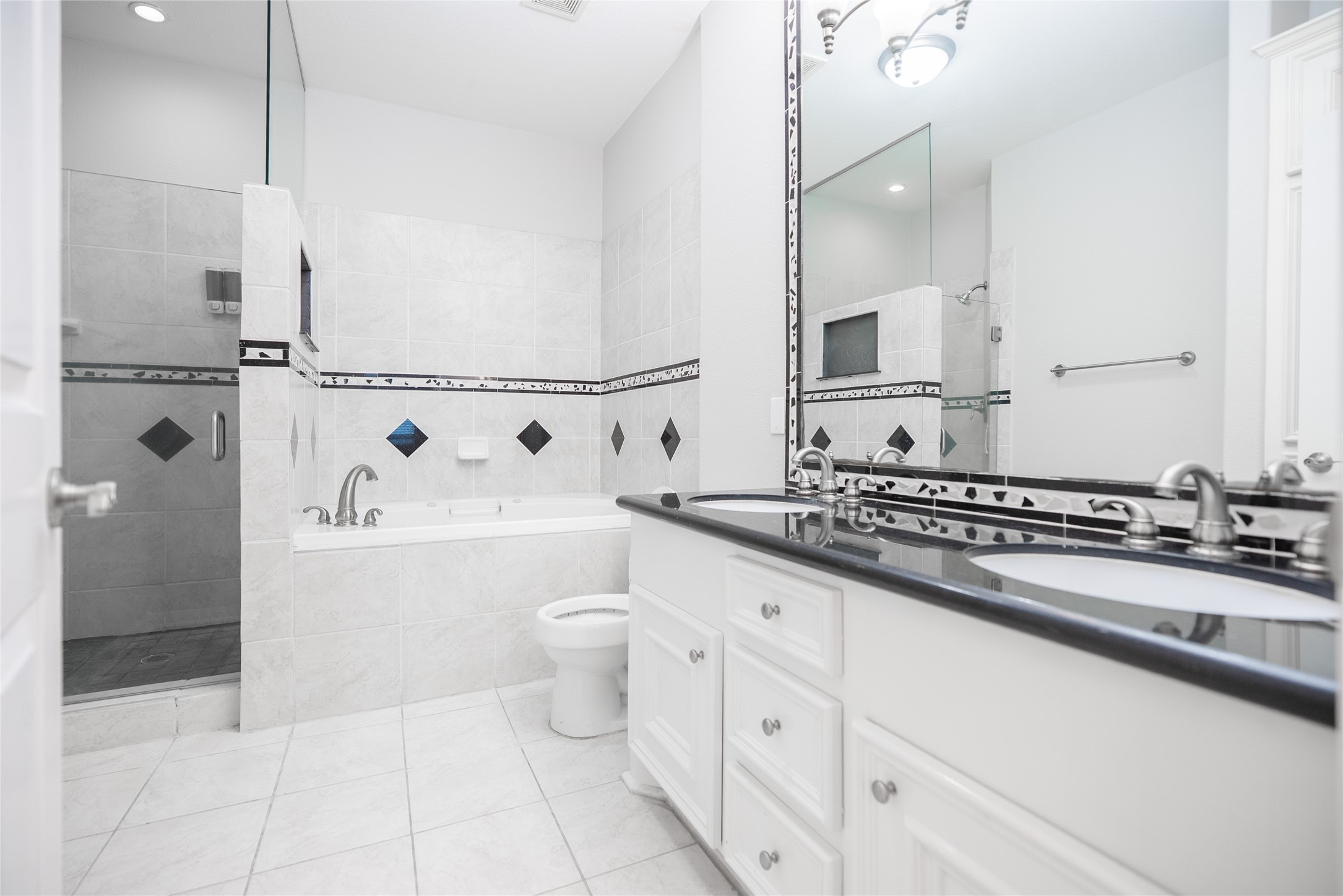 13165 Snow Lane, Unit 1 Willis, TX 77318 - Photo 16 of 34 a bathroom with a sink a toilet and a mirror