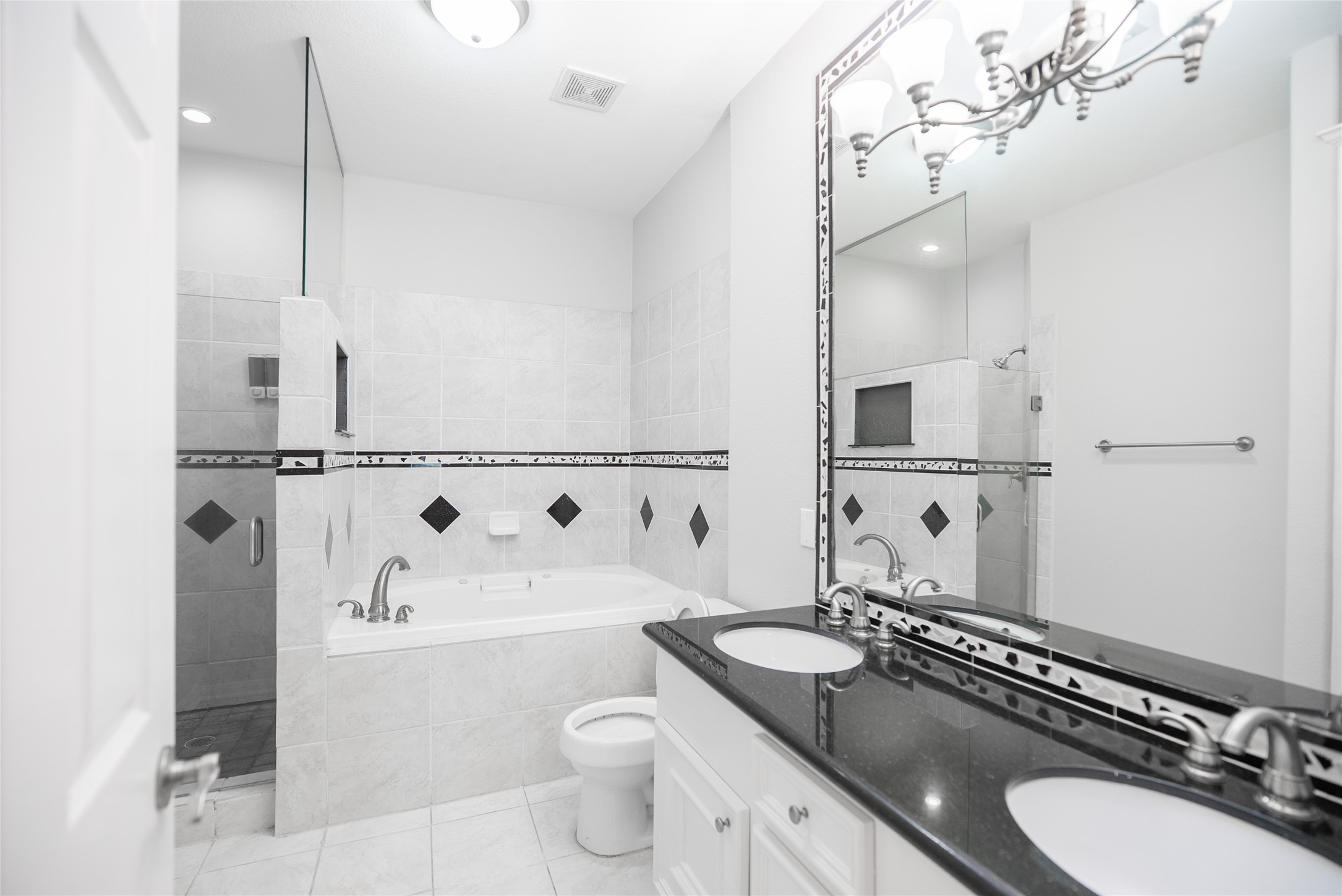 13165 Snow Lane, Unit 1 Willis, TX 77318 - Photo 21 of 34 a bathroom with a granite countertop sink mirror vanity and toilet